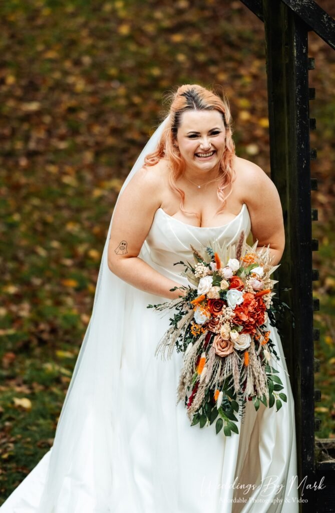 Candid wedding photography of Alexanne and Luke laughing during their wedding portraits in Cheshire