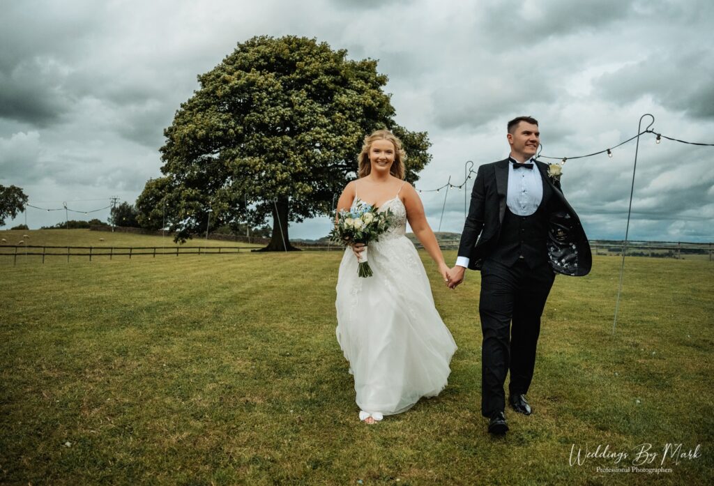 Couple portrait under the iconic sycamore tree at Heaton House Farm with views of the Cheshire plains.