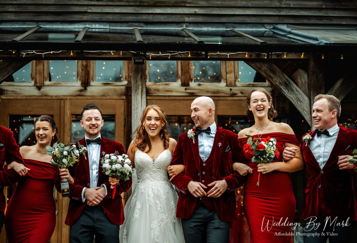 Wedding party walking arm in arm