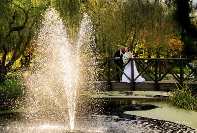 Bride and Groom on the wooden bridge at Grosvenor Pulford Hotel