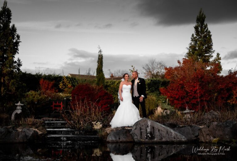 Bride and Groom on the wooden bridge in the Japanese Gardens at Grosvenor Pulford Hotel