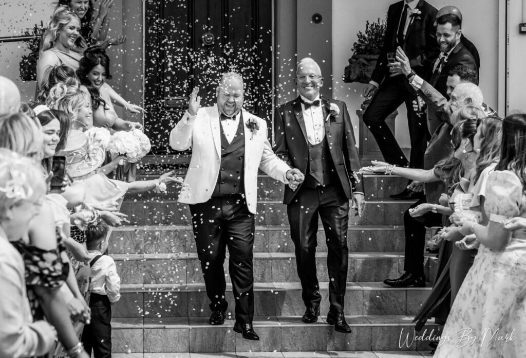 Joyful confetti moment at a same-sex wedding in the Conwy Valley.