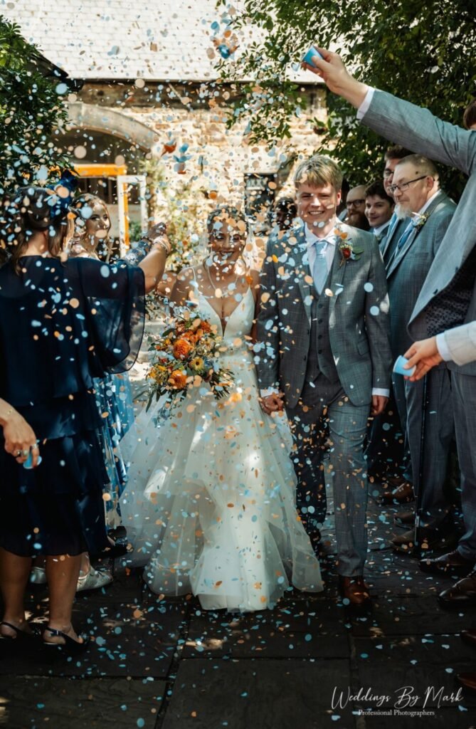 Joyful confetti moment in the gardens of Mosborough Hall Hotel.