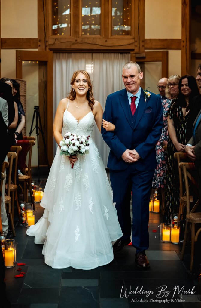 Proud father walking Katie down the aisle at The Oak Tree of Peover, captured by an affordable wedding photographer in Cheshire
