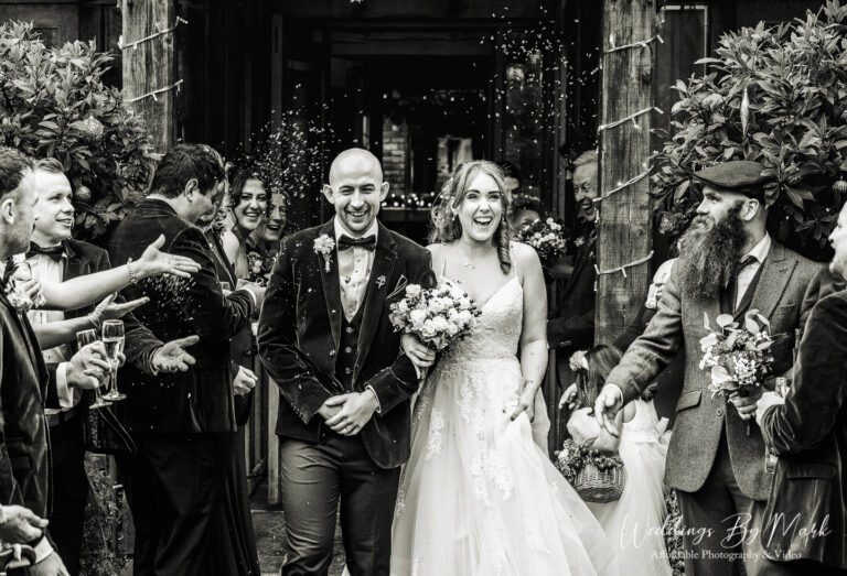 Classic black and white confetti exit shot at The Oak Tree of Peover captured by a Cheshire wedding photographer