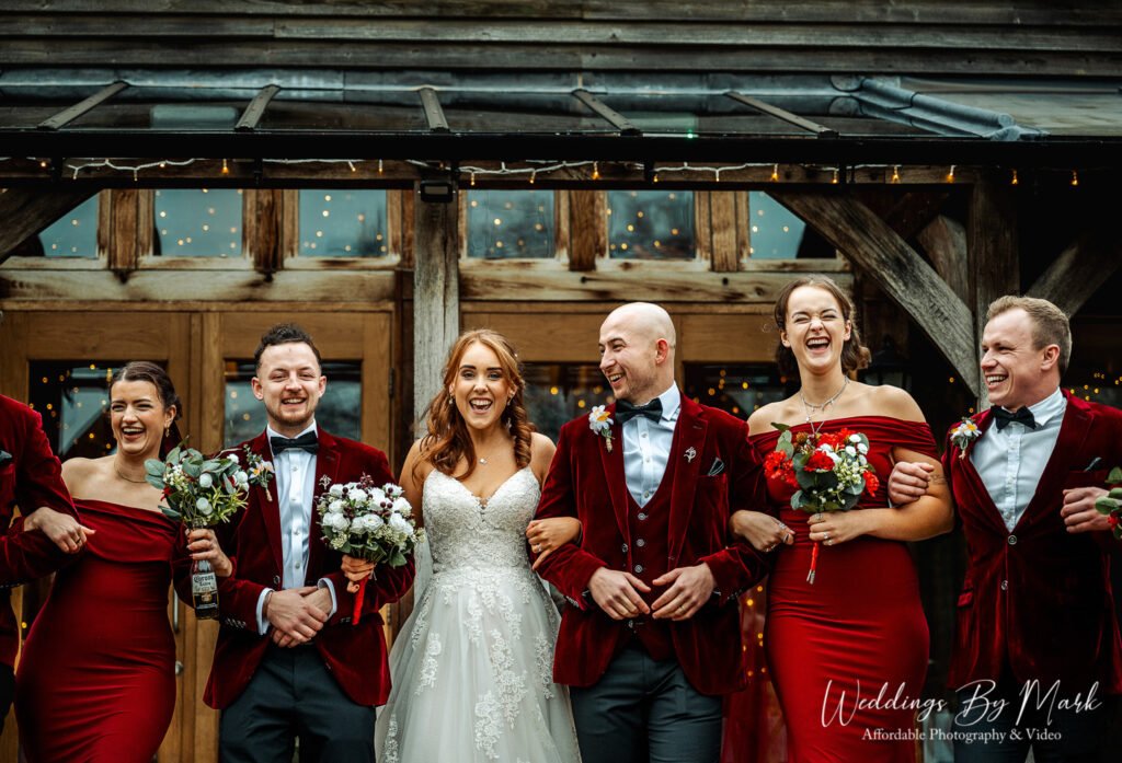 Joyful bridal party walking and laughing at The Oak Tree of Peover, captured by a Cheshire wedding photographer