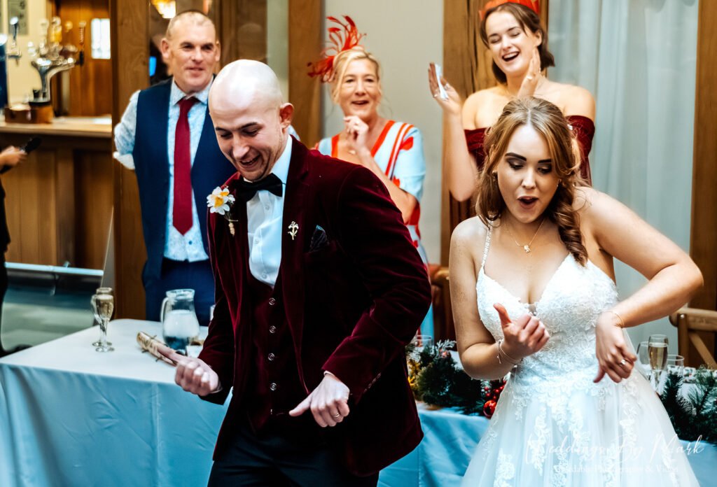 Groom Mathew showing off his dance moves next to Katie during the wedding reception party at The Oak Tree of Peover
