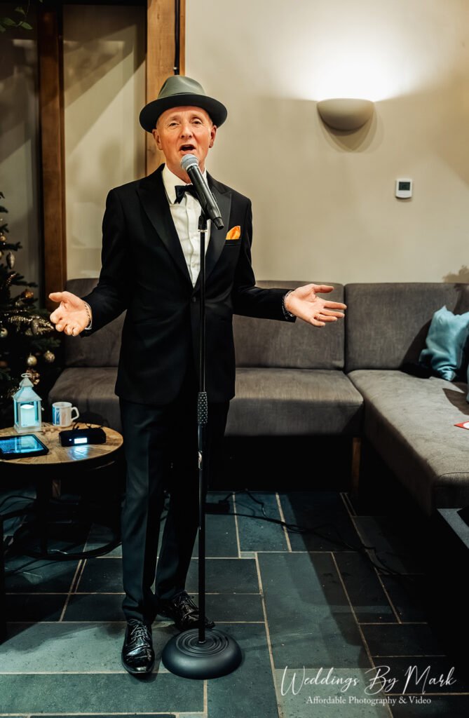 A shot of the live singer performing with a microphone and hat, setting the mood for the evening reception