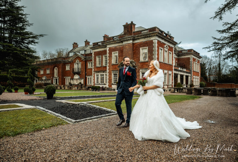 Maria and Jonny embracing in the winter light outside Eaves Hall, Lancashire Hybrid wedding photography.