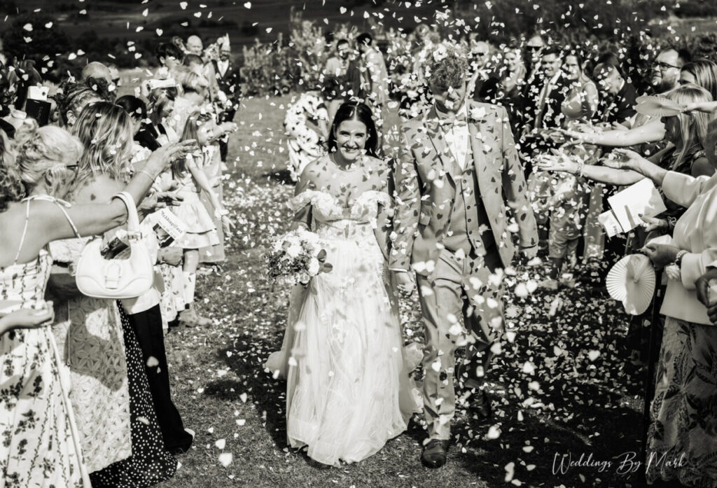 Wedding guests celebrating with confetti at Grains Bar Hotel in Oldham, photographed by Weddings By Mark
