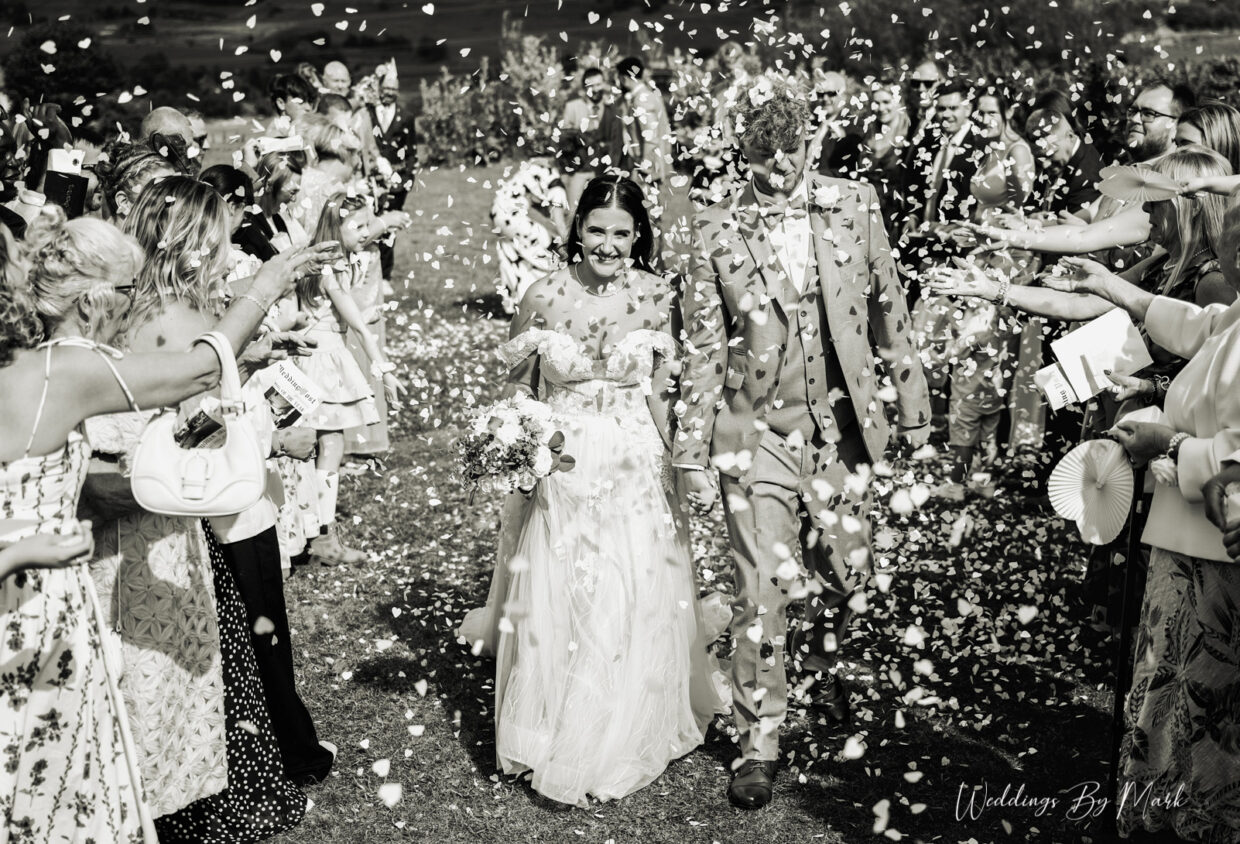 Guests celebrating with confetti at a Greater Manchester wedding photographed by Weddings By Mark