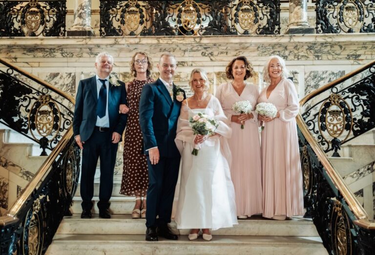Karen and David with family on the staircase at Stockport Town Hall
