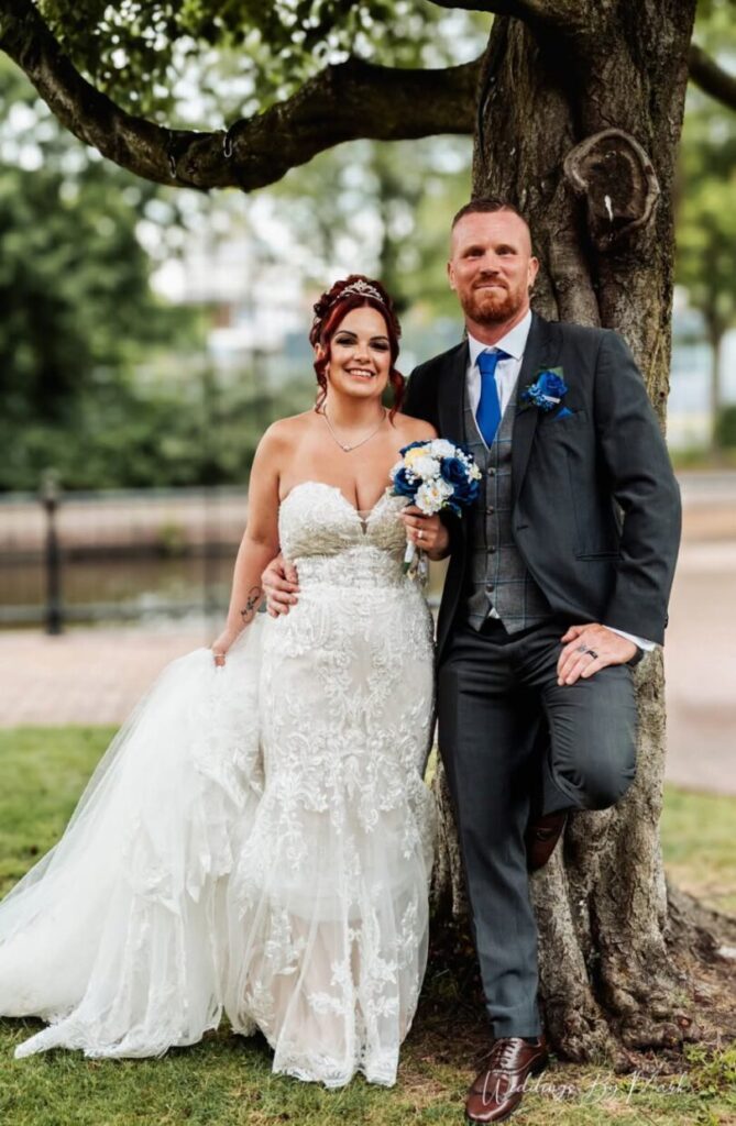 Bride and groom beside a tree at Mercure St Helens, photographed by Weddings By Mark