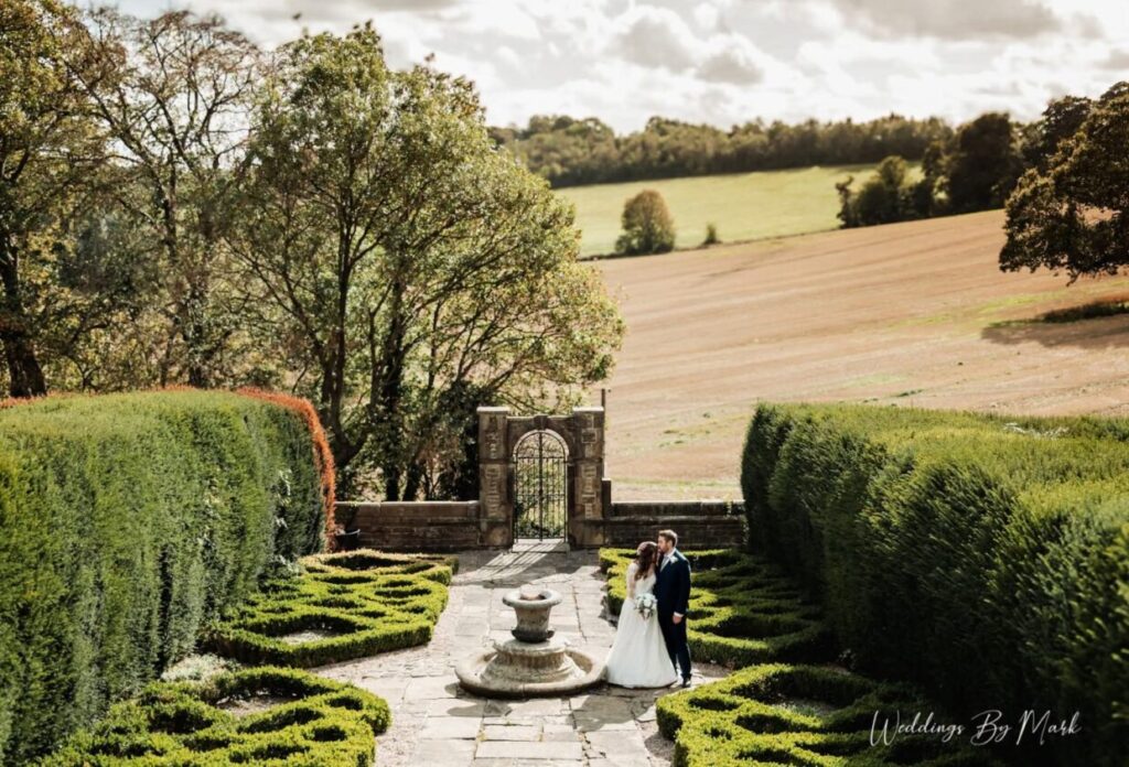 Bride and groom together in the formal gardens at Ringwood Hall Hotel and Spa near Chesterfield